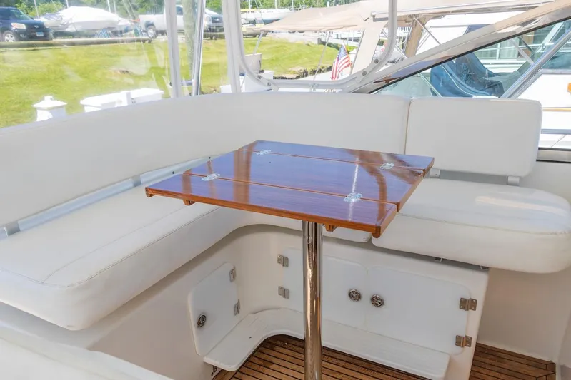 Salty Witch Yacht Photos Pics 1998 Grand Banks 38 Eastbay EX interior with white seating and polished wooden table.