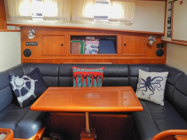 Salty Witch Yacht Photos Pics Interior of 1998 Grand Banks 38 Eastbay EX with cozy seating and nautical-themed pillows.
