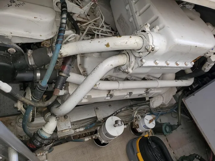 Salty Witch Yacht Photos Pics Engine compartment of a 1998 Grand Banks 38 Eastbay EX, showcasing pipes and mechanical components.