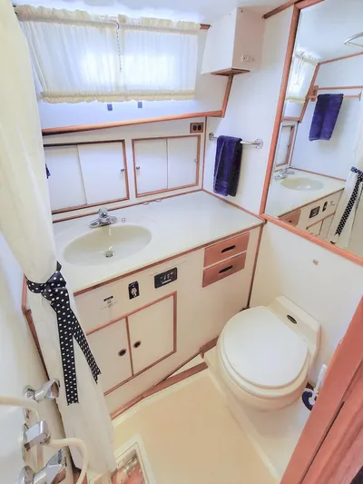 Salty Witch Yacht Photos Pics 1998 Grand Banks 38 Eastbay EX bathroom with sink, toilet, and storage cabinets.