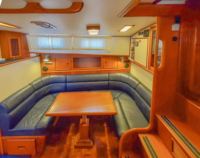 Salty Witch Yacht Photos Pics Luxurious interior of 1998 Grand Banks 38 Eastbay EX with blue leather seating and wooden table.
