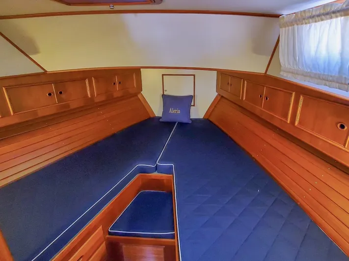 Salty Witch Yacht Photos Pics 1998 Grand Banks 38 Eastbay EX cabin with wooden interior and blue cushions.
