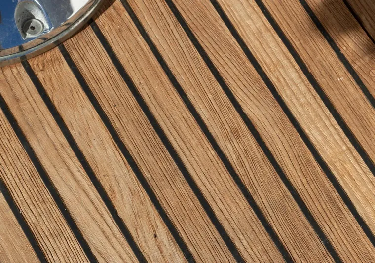 Salty Witch Yacht Photos Pics Teak deck of 1998 Grand Banks 38 Eastbay EX yacht, showcasing elegant wood grain.