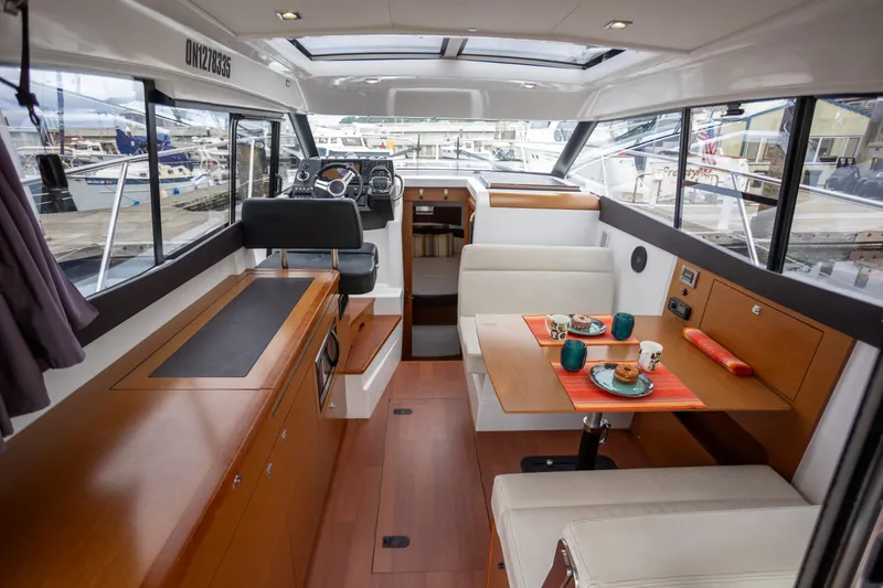 Myrt Yacht Photos Pics Interior of 2016 Jeanneau NC9 yacht with dining area and helm station.