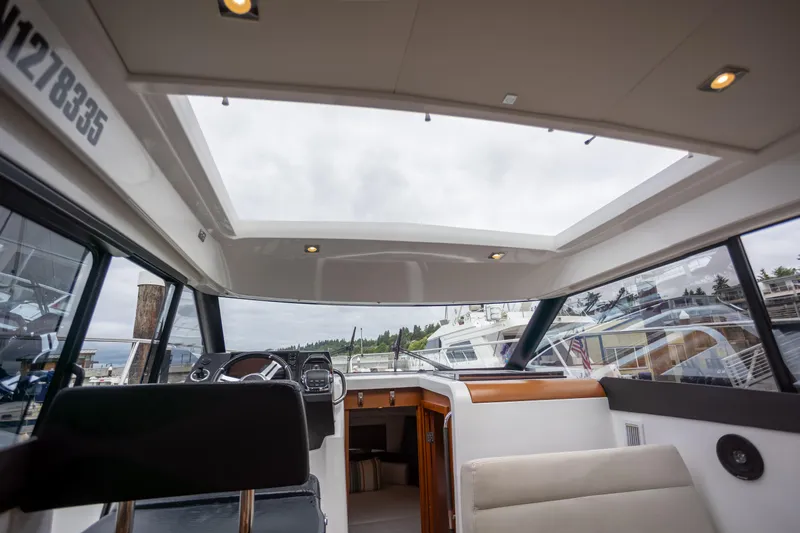 Myrt Yacht Photos Pics Interior view of 2016 Jeanneau NC9 boat with skylight and seating area.
