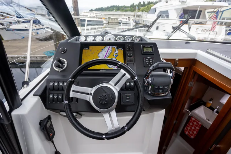 Myrt Yacht Photos Pics Helm of 2016 Jeanneau NC9 boat with navigation system and controls.