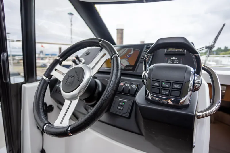 Myrt Yacht Photos Pics Steering wheel and controls of a 2016 Jeanneau NC9 boat.