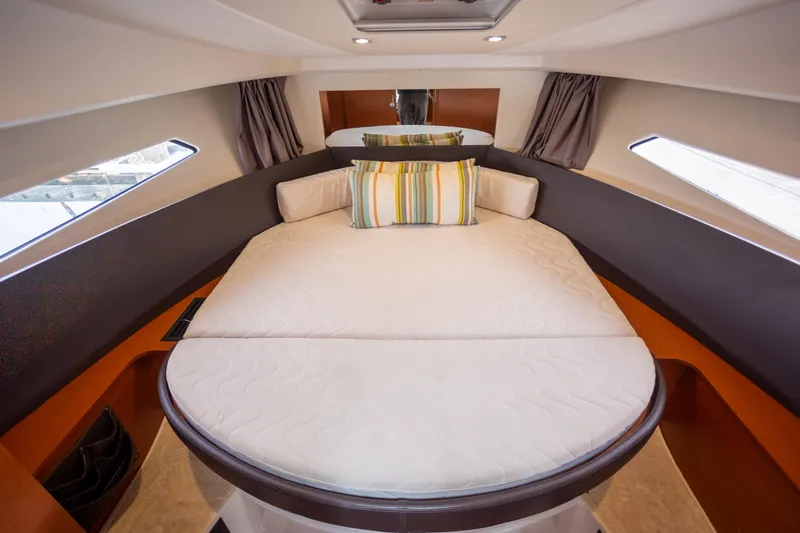 Myrt Yacht Photos Pics Luxurious cabin interior of 2016 Jeanneau NC9 yacht with comfortable bedding.