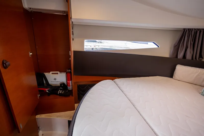 Myrt Yacht Photos Pics Interior cabin of 2016 Jeanneau NC9 boat with bed and storage.