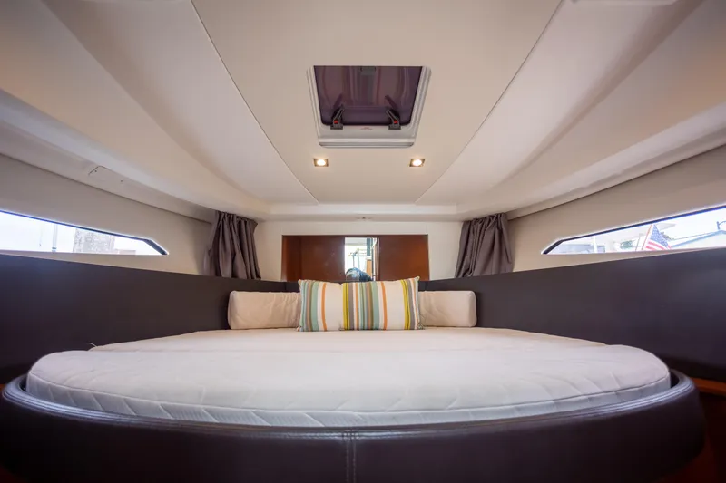 Myrt Yacht Photos Pics Interior cabin of 2016 Jeanneau NC9 yacht with round bed and skylight.
