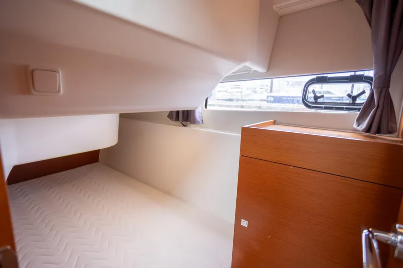 Myrt Yacht Photos Pics Cabin interior of 2016 Jeanneau NC9 boat with bed and window.