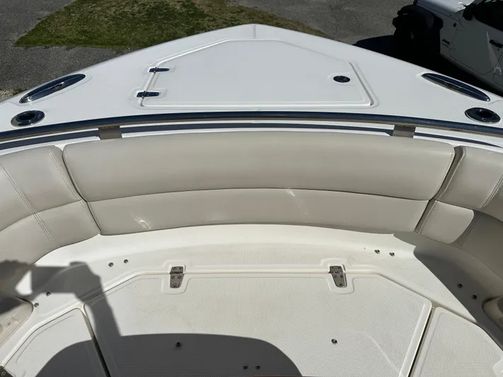 Dream Chaser Yacht Photos Pics 2021 Boston Whaler Realm 380 boat bow with cushioned seating and storage compartments.