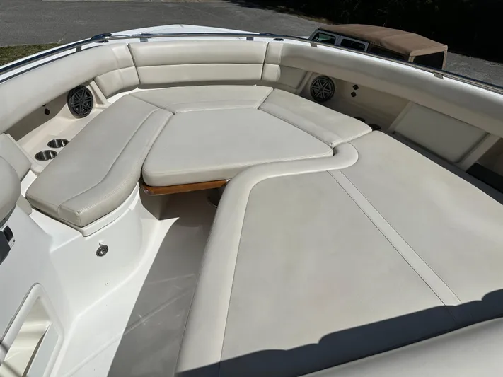 Dream Chaser Yacht Photos Pics 2021 Boston Whaler Realm 380 boat interior with cushioned seating area.