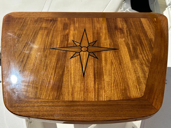 Dream Chaser Yacht Photos Pics Wooden table with compass rose design on a 2021 Boston Whaler Realm 380 boat.
