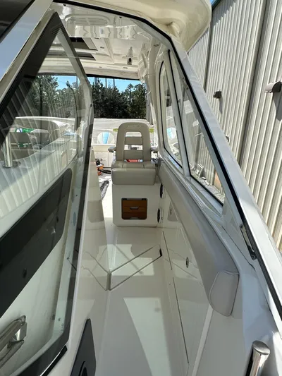 Dream Chaser Yacht Photos Pics 2021 Boston Whaler Realm 380 boat interior with seating and sleek design.