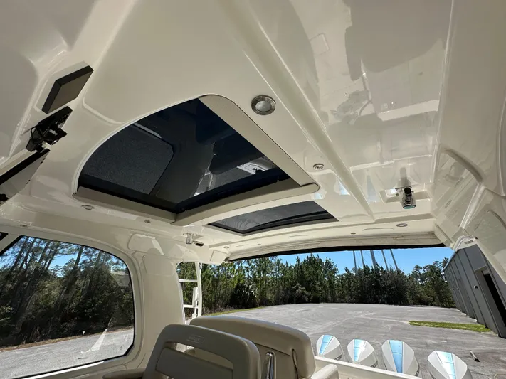 Dream Chaser Yacht Photos Pics 2021 Boston Whaler Realm 380 interior roof with sunroof and seating, showcasing luxury design.