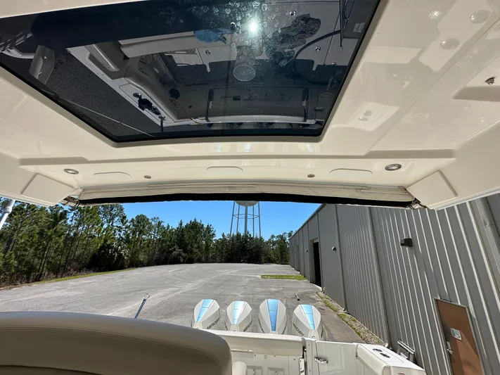 Dream Chaser Yacht Photos Pics 2021 Boston Whaler Realm 380 boat interior with sunroof and outboard motors.