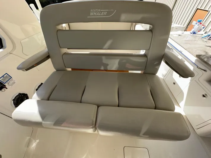 Dream Chaser Yacht Photos Pics Boston Whaler Realm 380 2021 boat seat with cushioned backrest and armrests.