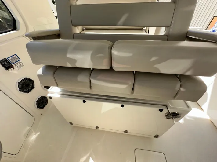 Dream Chaser Yacht Photos Pics 2021 Boston Whaler Realm 380 interior seating, featuring cushioned seats and modern design.