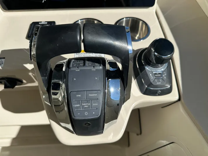 Dream Chaser Yacht Photos Pics Control panel of a 2021 Boston Whaler Realm 380 boat, featuring throttle and joystick.
