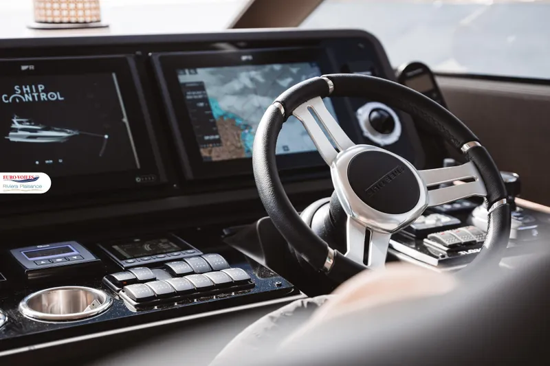 Sea Change Yacht Photos Pics Cockpit of 2021 Prestige 590 Fly yacht with advanced navigation controls and steering wheel.