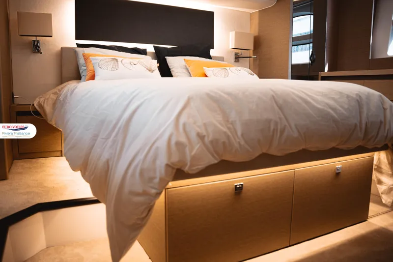 Sea Change Yacht Photos Pics Luxurious bedroom interior of 2021 Prestige 590 Fly yacht with elegant bedding and ambient lighting.