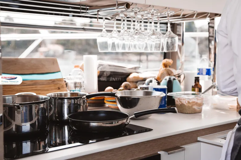 Sea Change Yacht Photos Pics Modern kitchen on 2021 Prestige 590 Fly yacht with cookware and utensils.