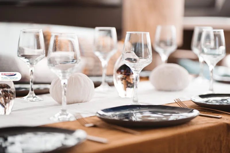 Sea Change Yacht Photos Pics Elegant dining setup on Prestige 590 Fly yacht, featuring wine glasses and plates, 2021 model.