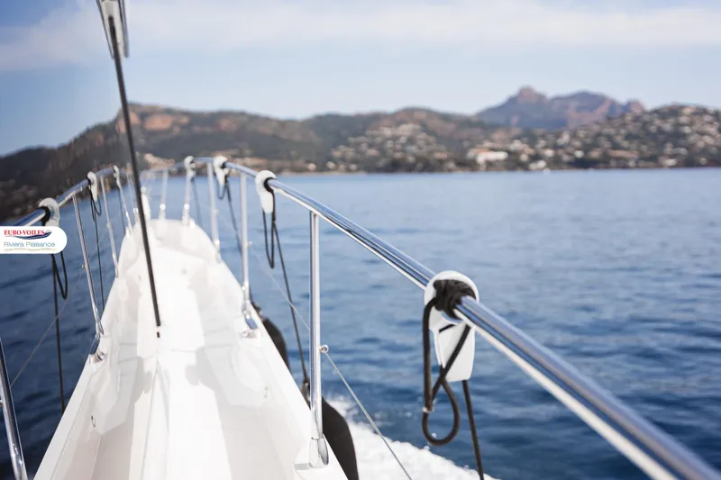 Sea Change Yacht Photos Pics 2021 Prestige 590 Fly yacht cruising on calm blue waters with scenic mountain backdrop.