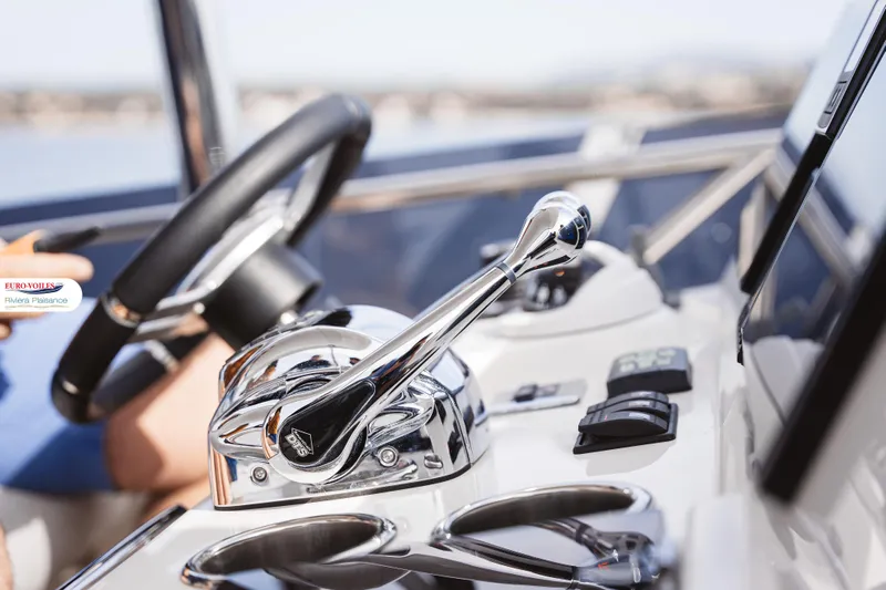 Sea Change Yacht Photos Pics Control panel of 2021 Prestige 590 Fly yacht with steering wheel and throttle lever.