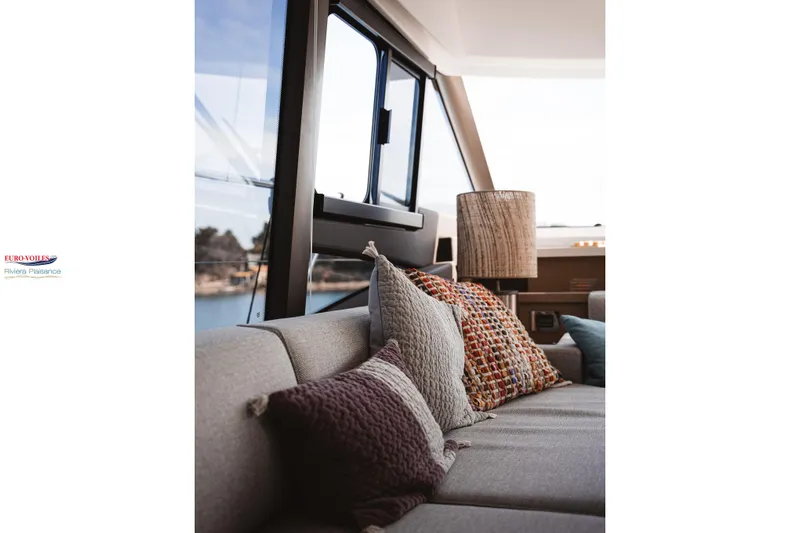 Sea Change Yacht Photos Pics Luxurious interior of 2021 Prestige 590 Fly yacht with cozy cushions and elegant decor.