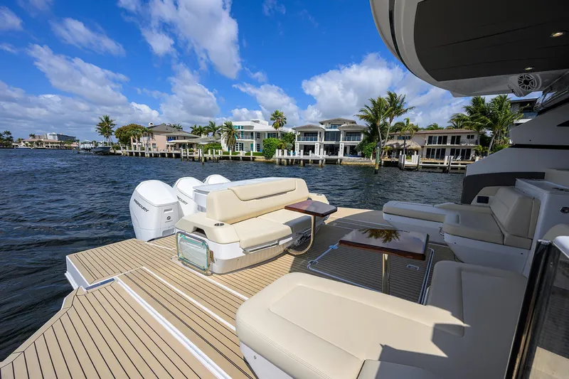 2024 Cruisers Yachts 50 Gls Outboard Yacht Photos Pics 2024 Cruisers Yachts GLS-OB on water, featuring luxurious seating and scenic waterfront homes.