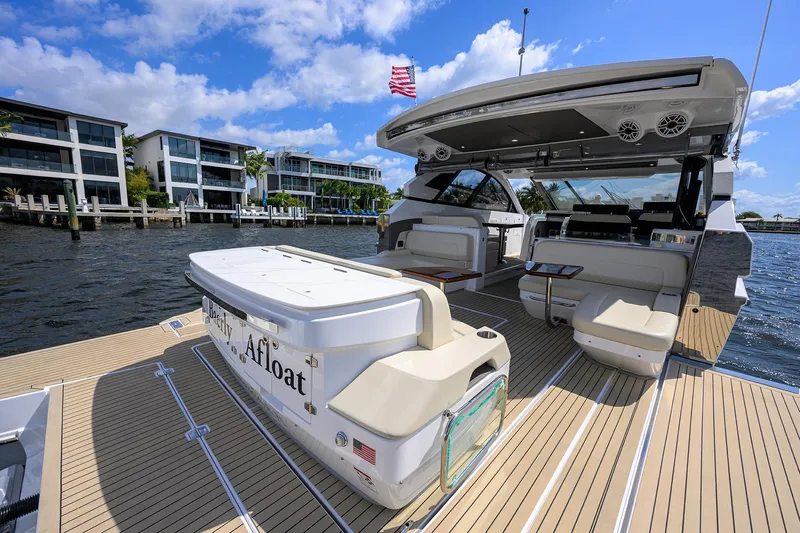 2024 Cruisers Yachts 50 Gls Outboard Yacht Photos Pics 2024 Cruisers Yachts GLS-OB on water, showcasing spacious deck and luxurious seating.