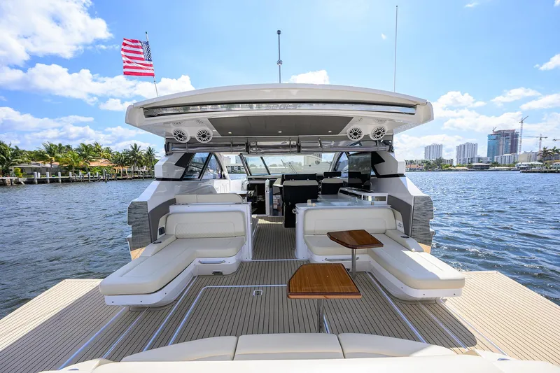 2024 Cruisers Yachts 50 Gls Outboard Yacht Photos Pics 2024 Cruisers Yachts GLS-OB on water, featuring luxurious seating and American flag.