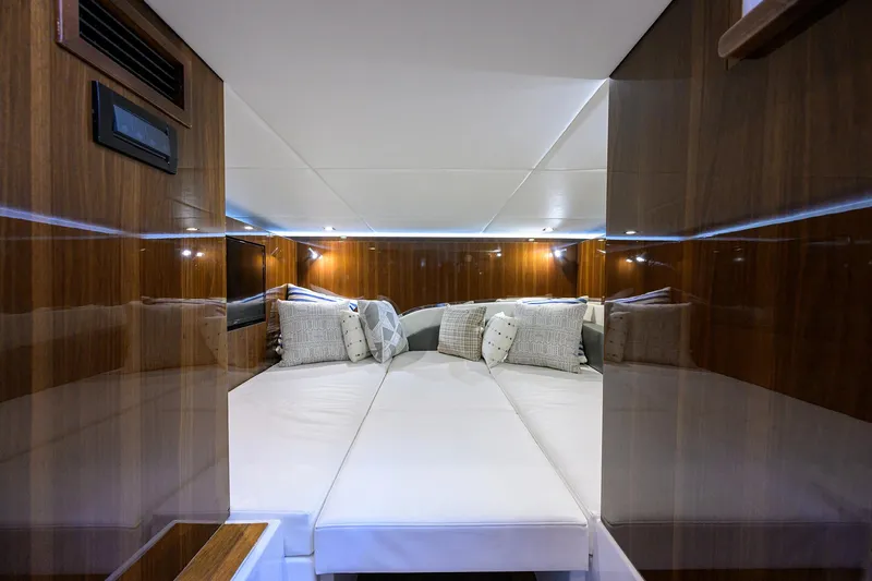 2024 Cruisers Yachts 50 Gls Outboard Yacht Photos Pics Luxurious cabin interior of 2024 Cruisers Yachts GLS-OB with elegant wood paneling.