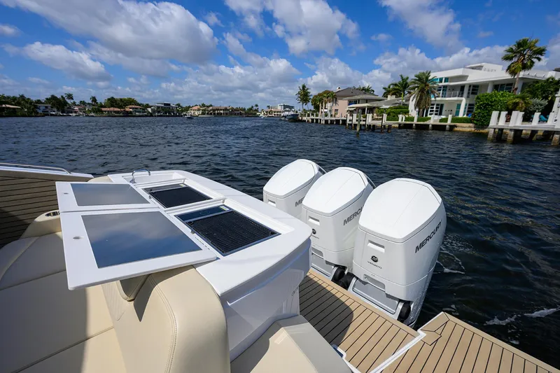 2024 Cruisers Yachts 50 Gls Outboard Yacht Photos Pics 2024 Cruisers Yachts GLS-OB with triple outboard engines on a sunny waterfront.