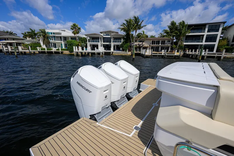 2024 Cruisers Yachts 50 Gls Outboard Yacht Photos Pics 2024 Cruisers Yachts GLS-OB with triple Mercury outboard engines, docked near waterfront homes.