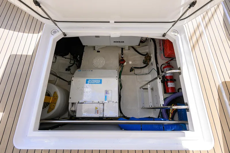 2024 Cruisers Yachts 50 Gls Outboard Yacht Photos Pics 2024 Cruisers Yachts GLS-OB engine compartment with equipment and fire extinguisher.