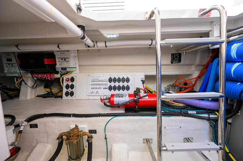 2024 Cruisers Yachts 50 Gls Outboard Yacht Photos Pics 2024 Cruisers Yachts GLS-OB engine room with control panel, wiring, and fire extinguisher.