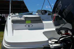 2024 Tahoe T18 boat with sleek design and powerful engine, under clear blue sky.