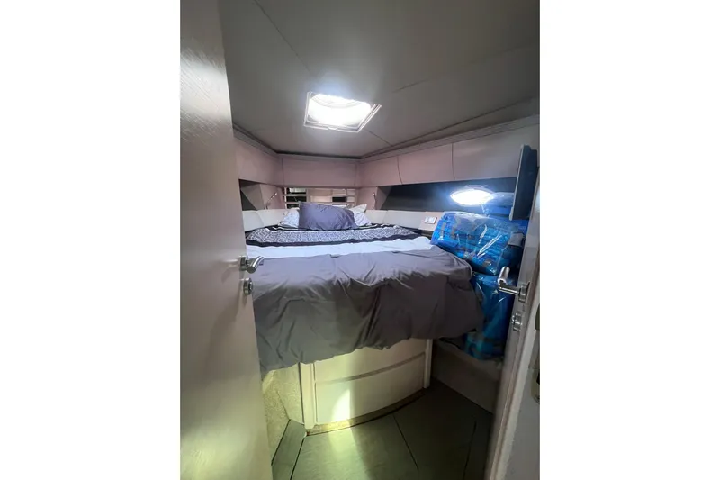  Yacht Photos Pics Cozy bedroom interior of 2006 Azimut Atlantis 55 yacht with skylight and modern design.