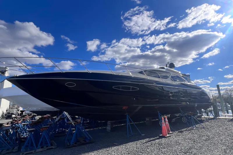 Yacht Photos Pics Azimut Atlantis 55 yacht from 2006 on stands under a bright blue sky.