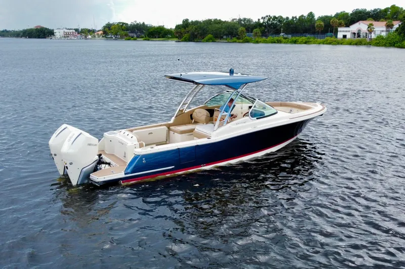  Yacht Photos Pics 2023 Chris-Craft Calypso 28 boat on calm water, featuring sleek design and modern outboard engines.