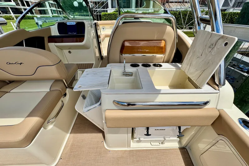  Yacht Photos Pics 2023 Chris-Craft Calypso 28 interior with luxurious seating and built-in sink.