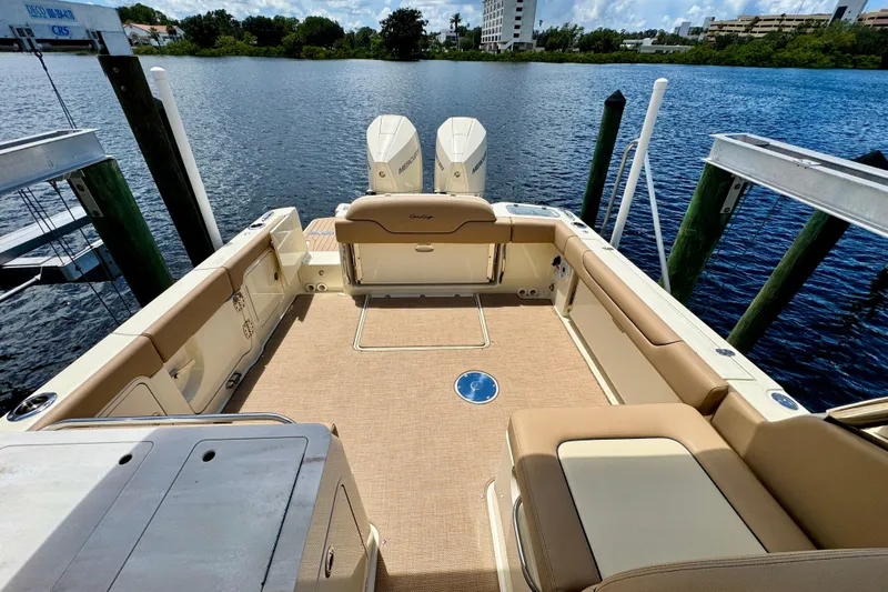  Yacht Photos Pics 2023 Chris-Craft Calypso 28 boat interior with seating, docked by the water.