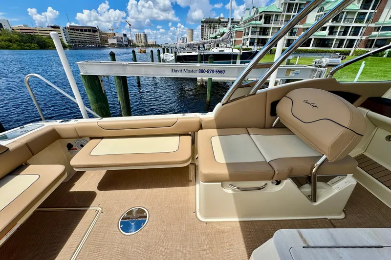  Yacht Photos Pics 2023 Chris-Craft Calypso 28 boat interior with tan seating and waterfront view.