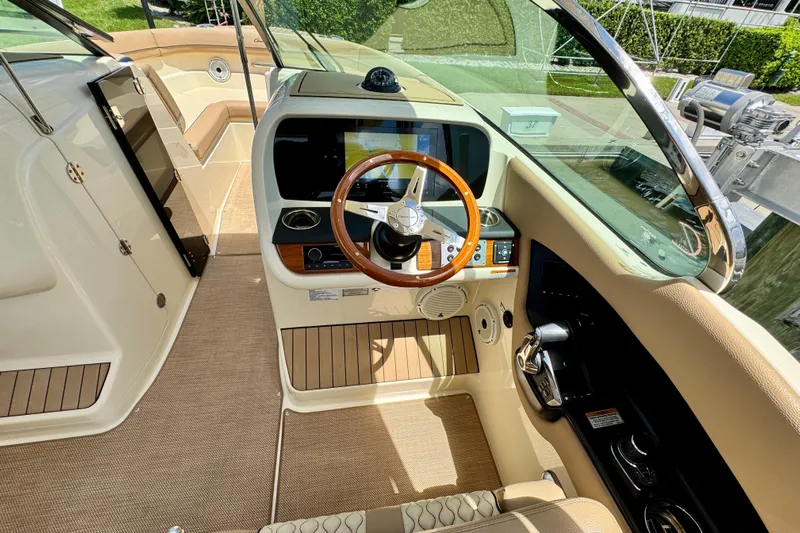  Yacht Photos Pics 2023 Chris-Craft Calypso 28 boat interior with elegant steering wheel and modern dashboard.