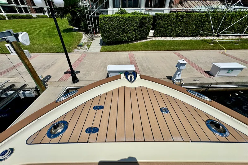  Yacht Photos Pics 2023 Chris-Craft Calypso 28 boat docked, showcasing elegant wooden deck design.