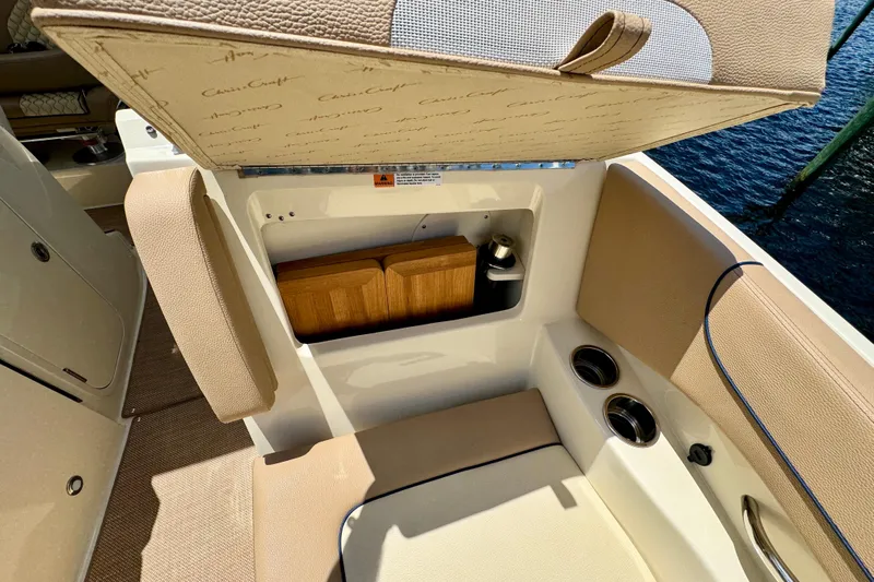  Yacht Photos Pics 2023 Chris-Craft Calypso 28 boat interior with storage compartment and cup holders.