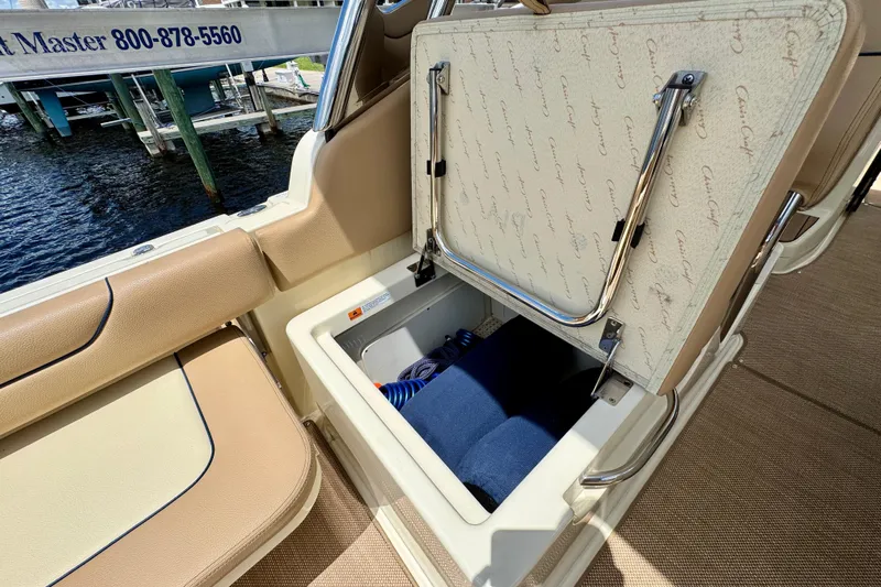  Yacht Photos Pics 2023 Chris-Craft Calypso 28 boat storage compartment with open lid, showcasing interior space.